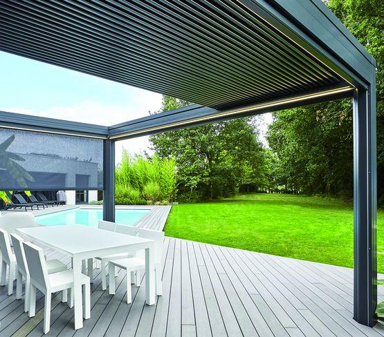 Bioclimatic aluminum motorized louver pergola over outdoor dining area with decking and pool view — luxury pergola Kenya