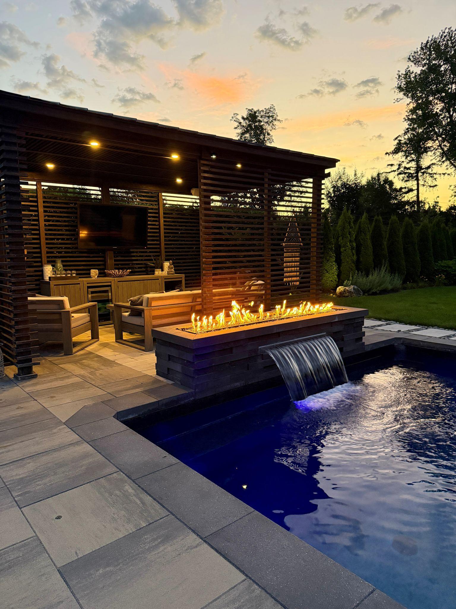 Luxury timber pergola with integrated recessed lighting over a sunken fire pit and infinity pool at sunset — AALIS Studios premium outdoor living Kenya