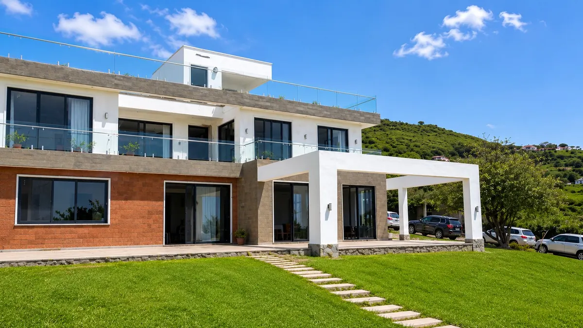 Villa Sori, a three-storey hillside home in Kenya with a white pergola, terracotta brick and glass balustrades, by Aalis Studios
