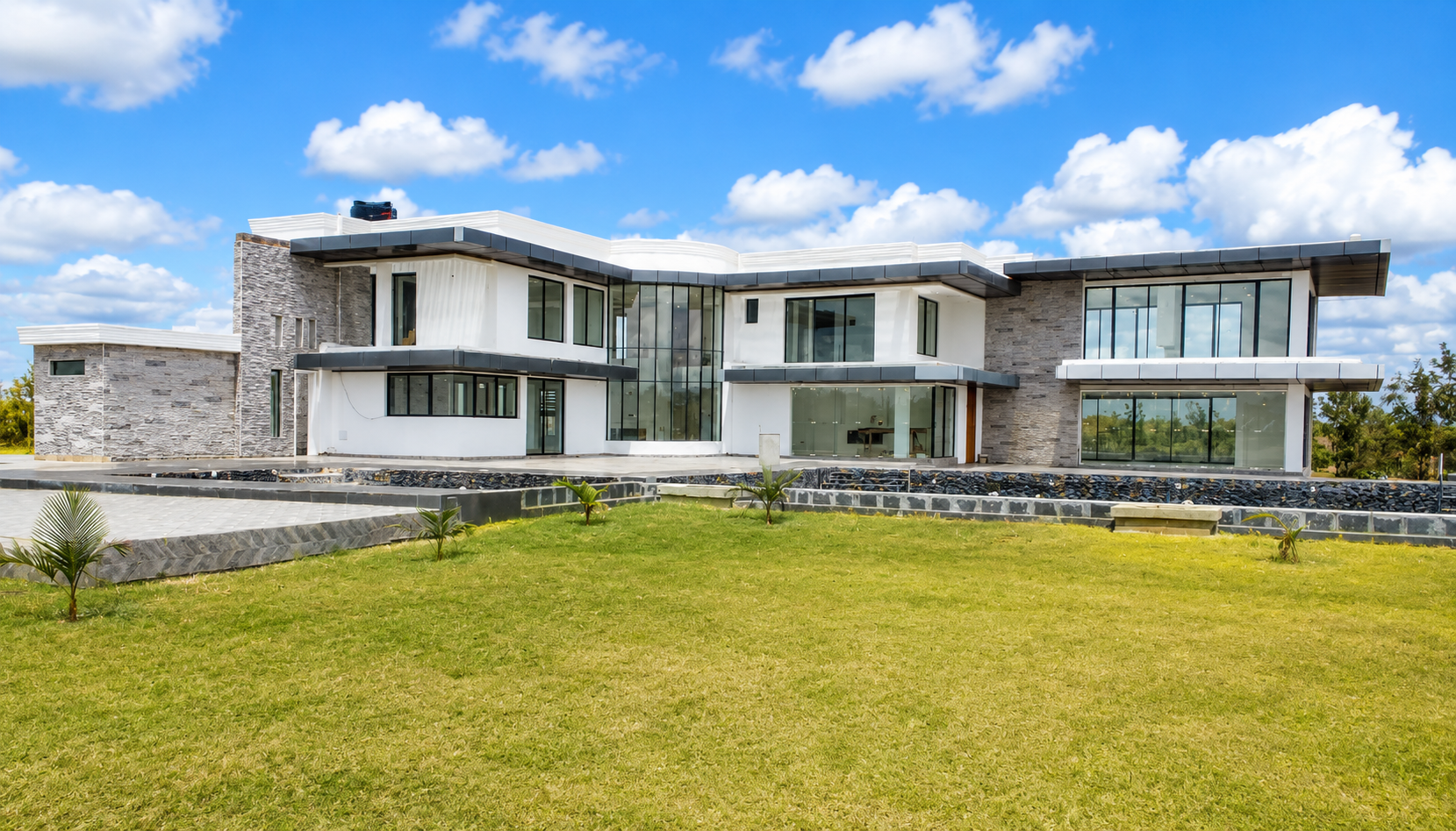 Completed rear elevation of Konza Mansion photographed from the lawn that holds the private mini golf course