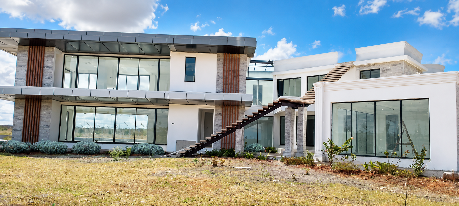 Completed rear elevation of Konza Mansion showing the main lounge glazing and exterior stair