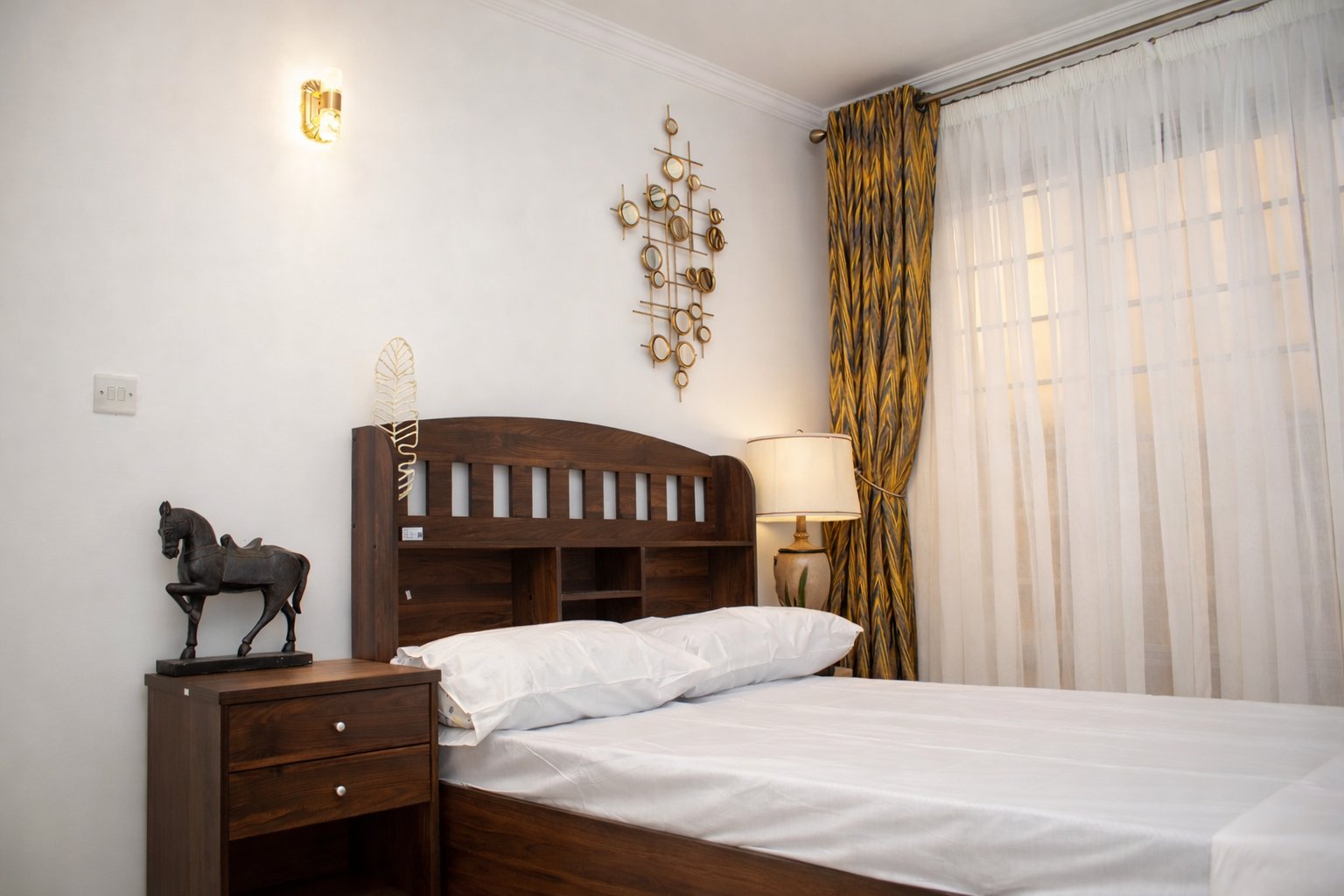 Elegant bedroom interior with gold accent decor in Twinfalls City bungalow, Malaa Kenya